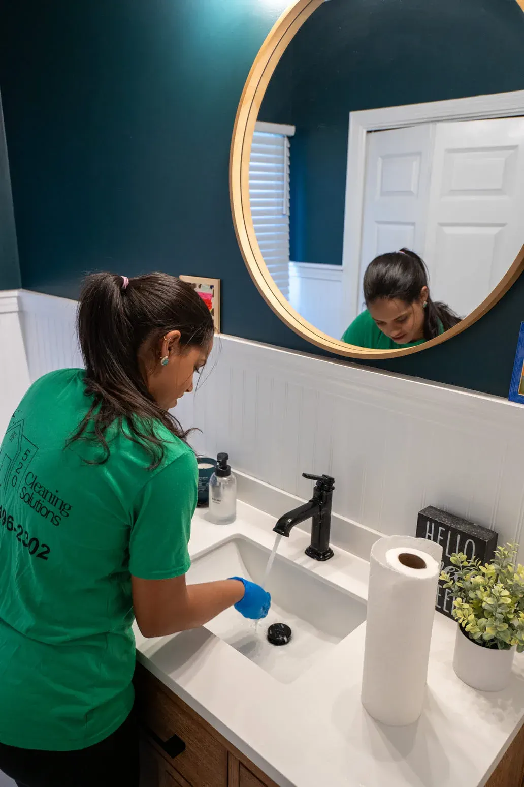 Team member wiping a bathroom vanity