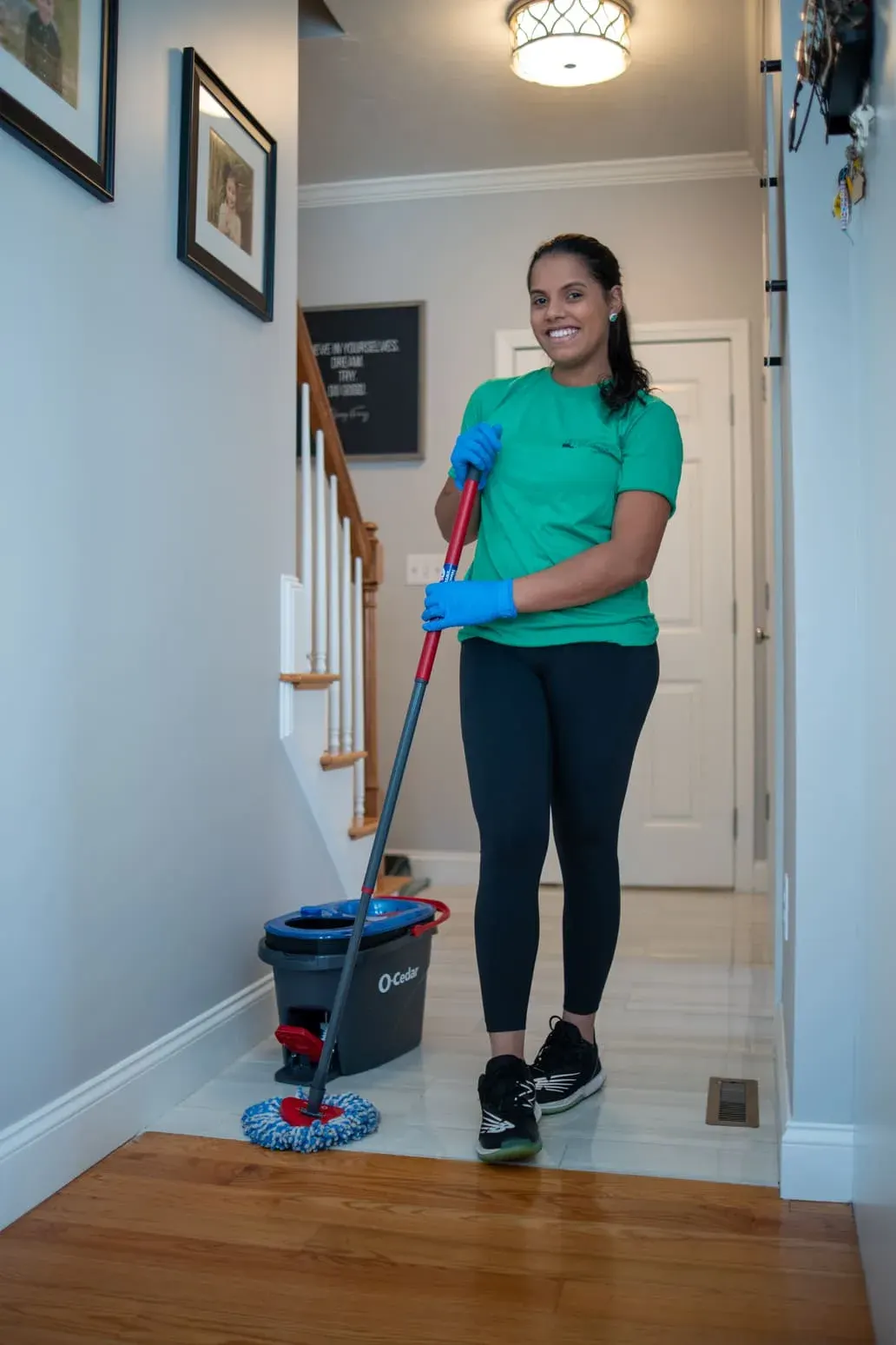 Team member mopping a hallway near the stairs